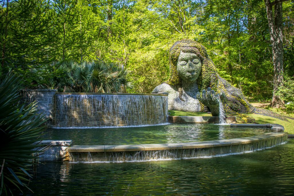 A female statue near a lake.