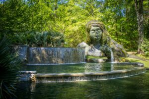 A female statue near a lake.