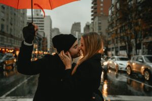 A man kissing a woman.