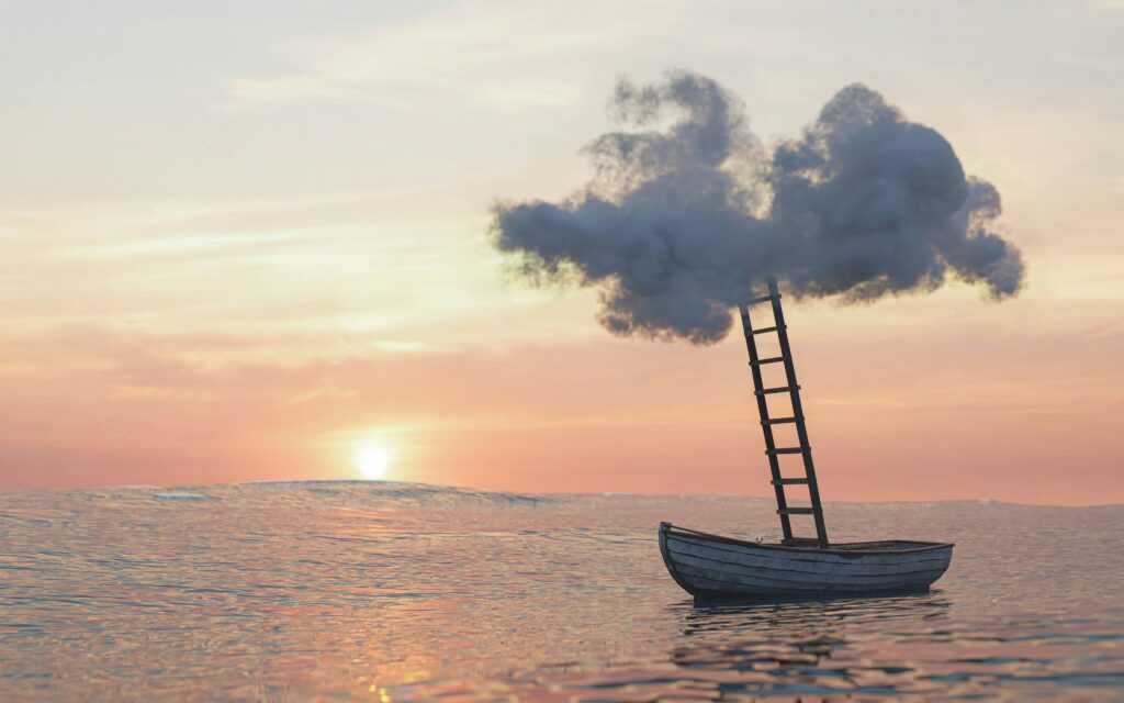 A boat in the ocean and sunset with a ladder leading upwards toward a cloud.