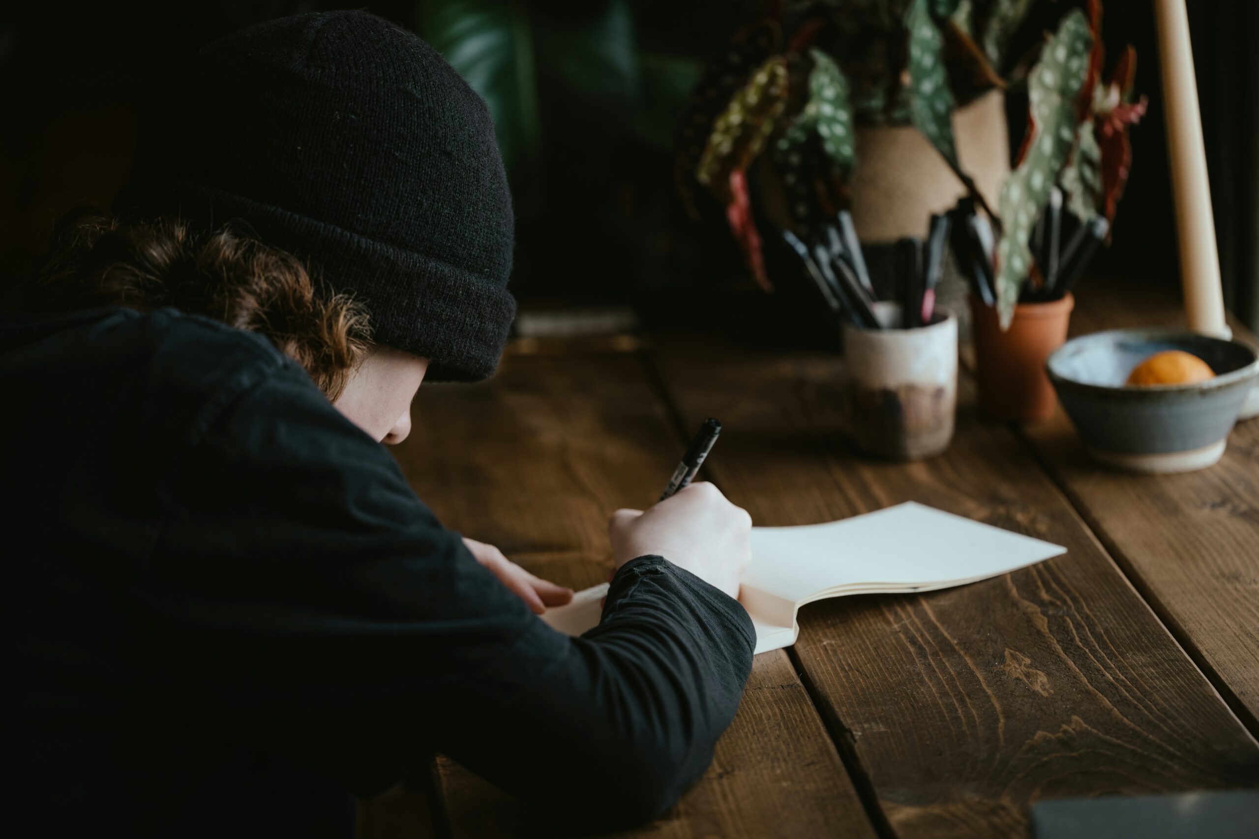 A young man is working on writing prompts.