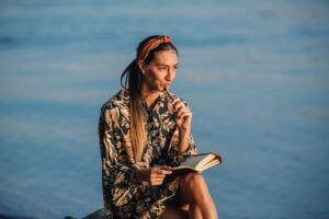 A woman with a book pondering.